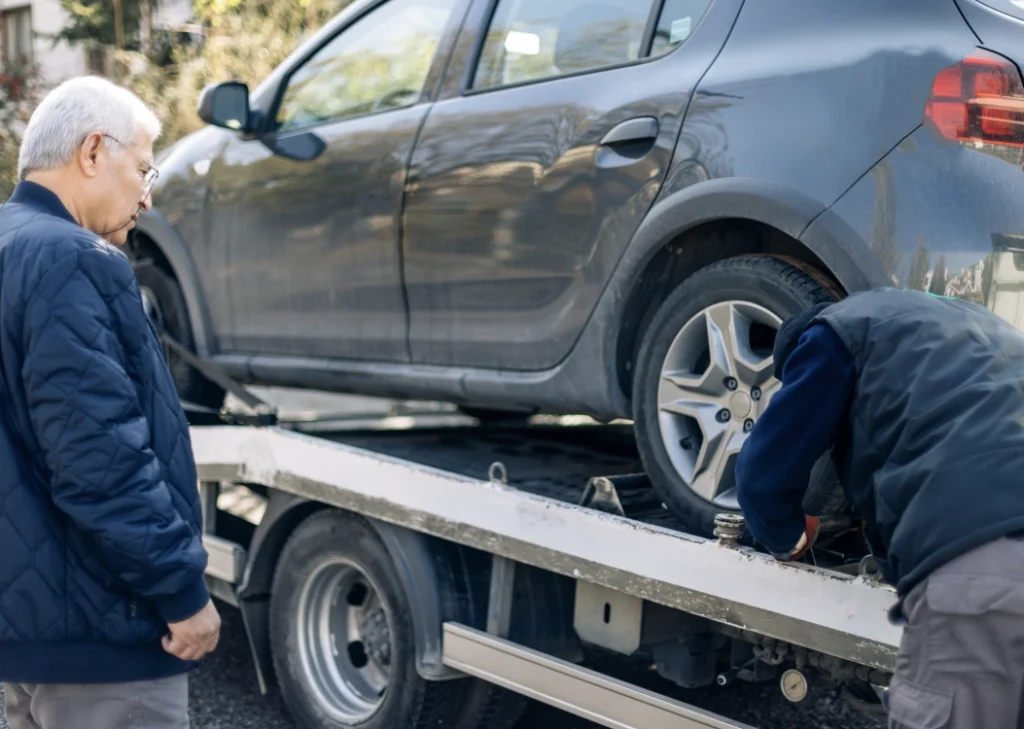 Breakdown Towing 3 customer waiting as car loaded on tow truck
